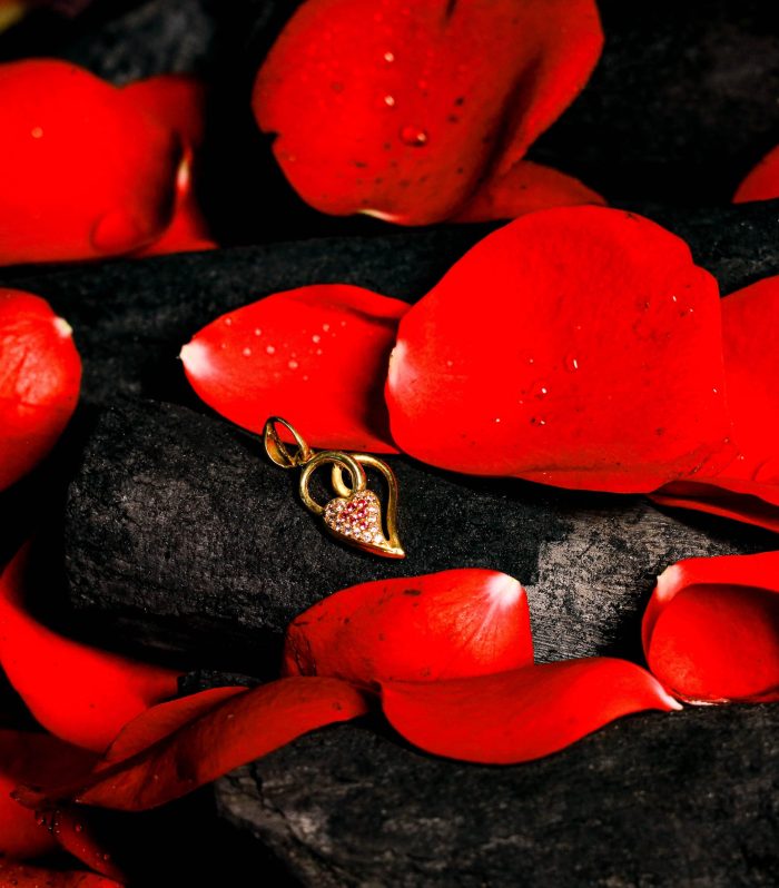 Gold Heart Pendant with Gemstones on Betel Leaf